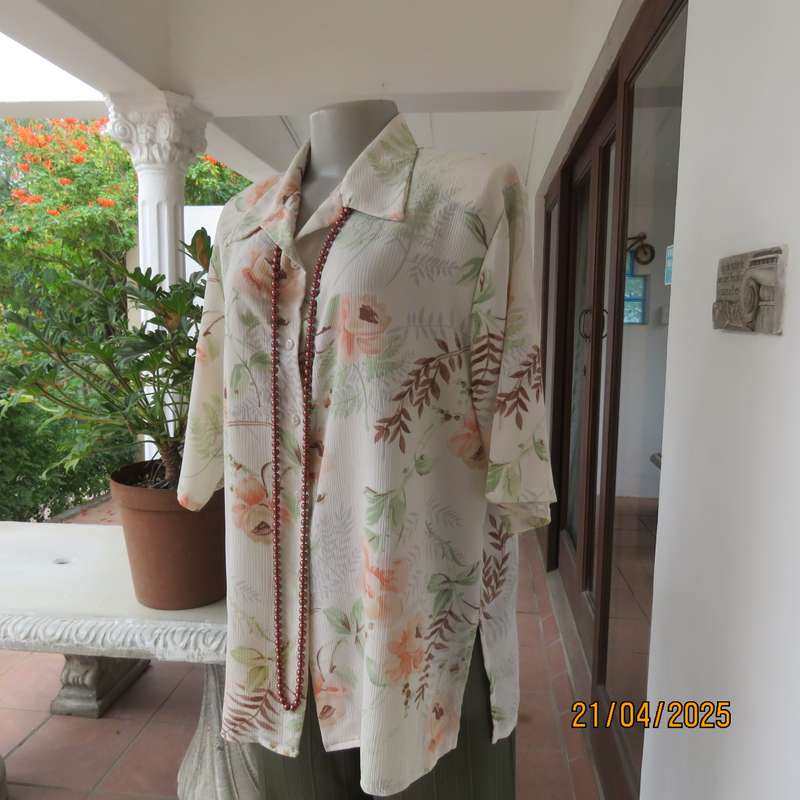 Tastefully printed short sleeve cream crinkled polyester top with peach flowers. Size 44