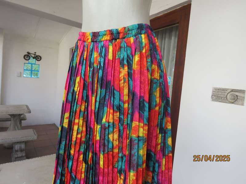 Colourful graphic printed satin embossed polyester permanent pleated skirt. Size 36