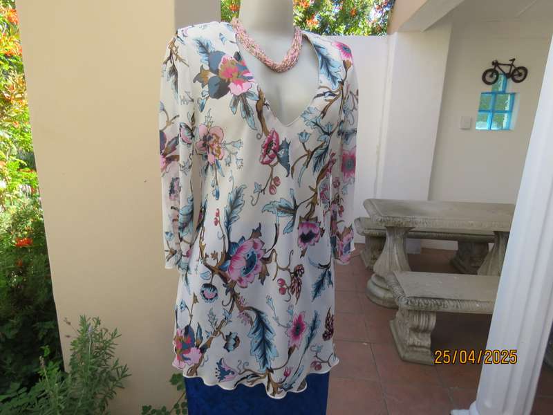 EXACT slip over white sheer polyester with blue-pink flowers. V neck. Size 36.