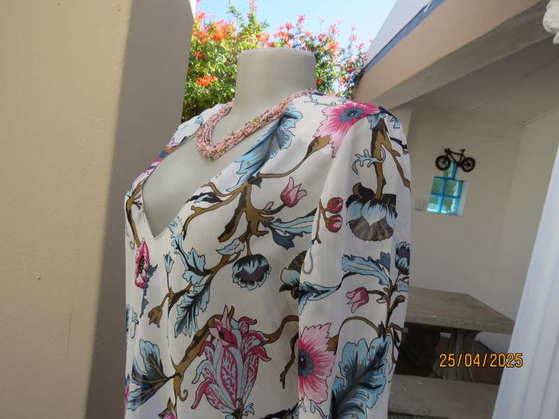 EXACT slip over white sheer polyester with blue-pink flowers. V neck. Size 36.
