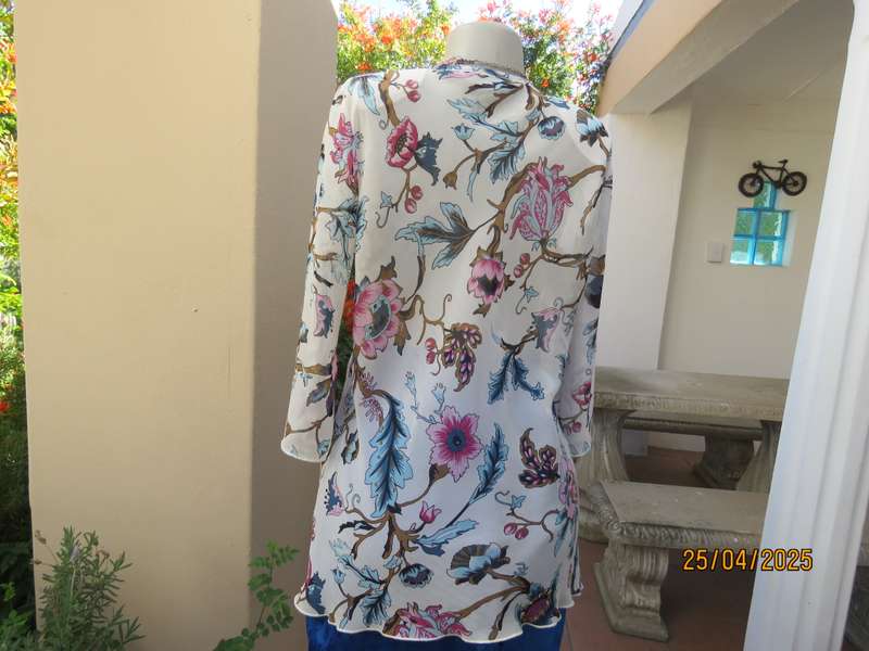 EXACT slip over white sheer polyester with blue-pink flowers. V neck. Size 36.