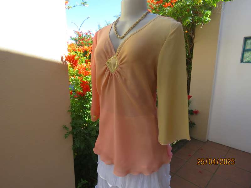 Slip over top in shades of peach colours with decoration on front. Size 36.