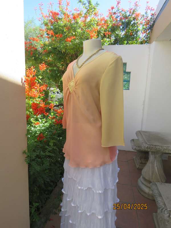 Slip over top in shades of peach colours with decoration on front. Size 36.