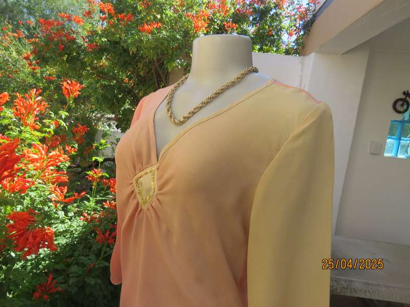 Slip over top in shades of peach colours with decoration on front. Size 36.