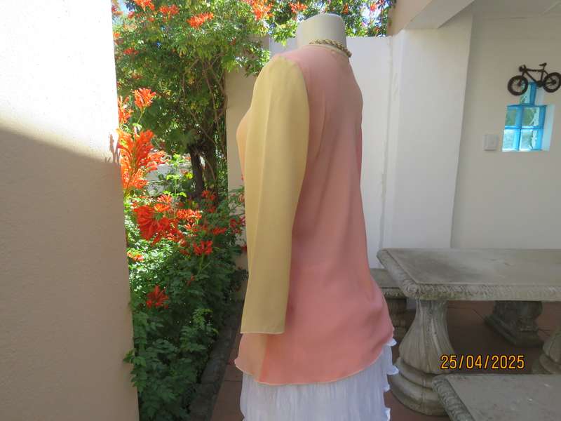 Slip over top in shades of peach colours with decoration on front. Size 36.