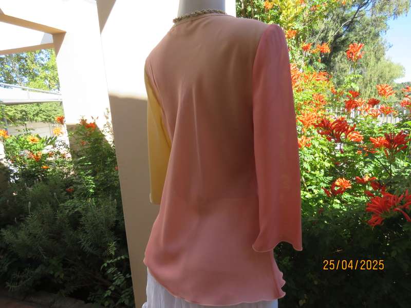 Slip over top in shades of peach colours with decoration on front. Size 36.