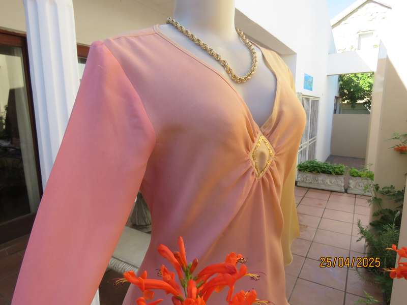 Slip over top in shades of peach colours with decoration on front. Size 36.
