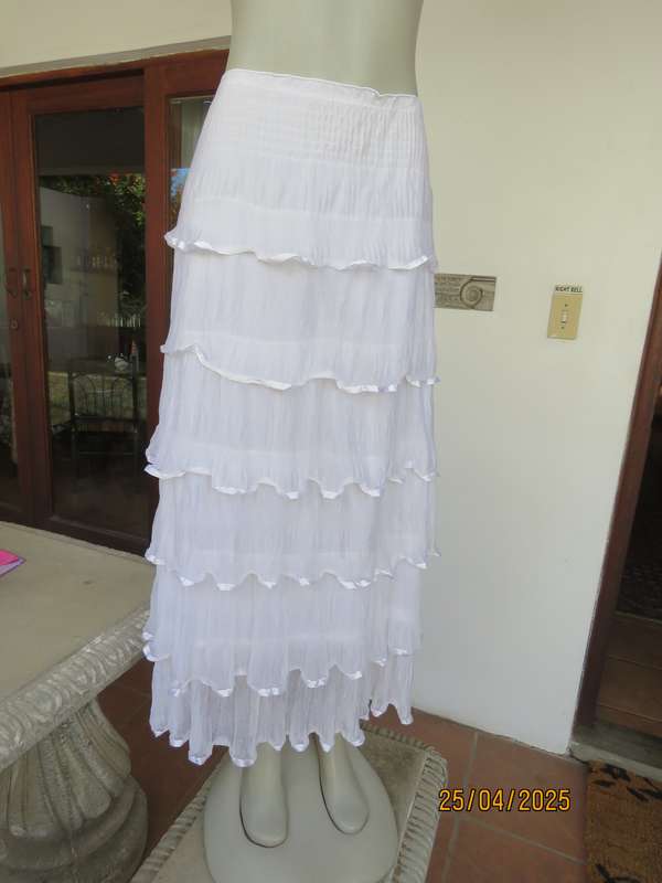 White maxi poly-nylon tiered-fully frilled skirt with wide elasticated waist. Size 40