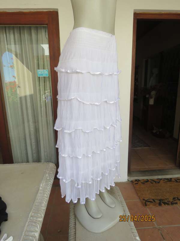 White maxi poly-nylon tiered-fully frilled skirt with wide elasticated waist. Size 40