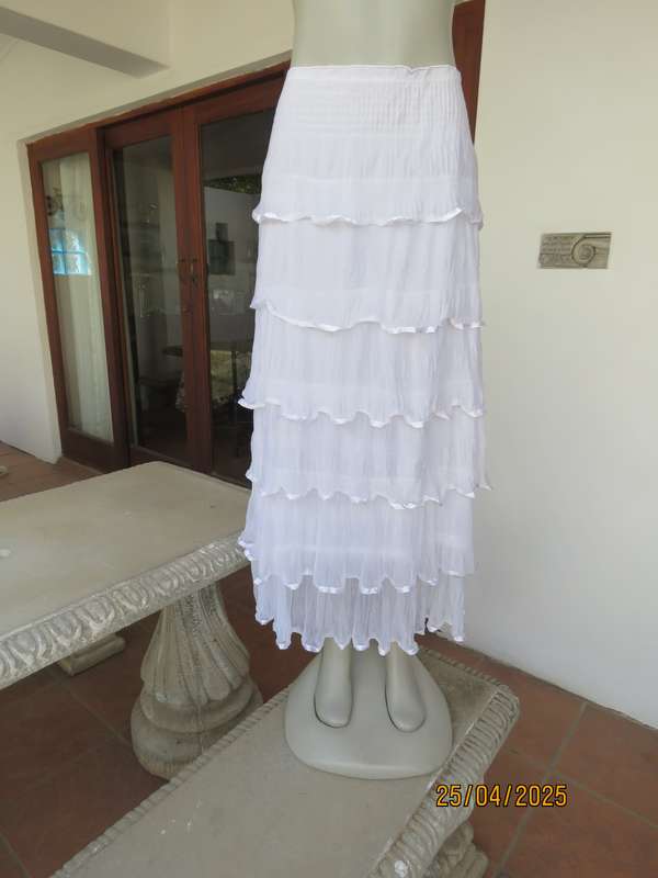 White maxi poly-nylon tiered-fully frilled skirt with wide elasticated waist. Size 40