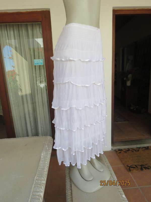 White maxi poly-nylon tiered-fully frilled skirt with wide elasticated waist. Size 40