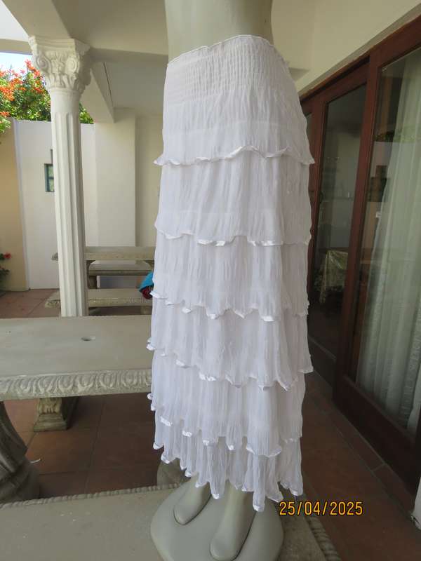 White maxi poly-nylon tiered-fully frilled skirt with wide elasticated waist. Size 40
