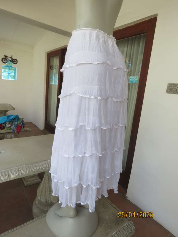 White maxi poly-nylon tiered-fully frilled skirt with wide elasticated waist. Size 40