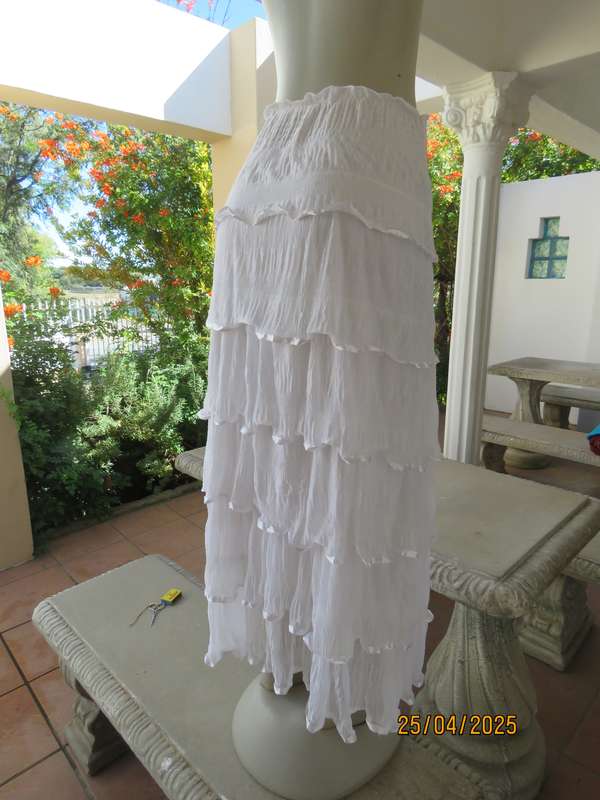 White maxi poly-nylon tiered-fully frilled skirt with wide elasticated waist. Size 40