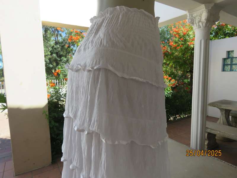 White maxi poly-nylon tiered-fully frilled skirt with wide elasticated waist. Size 40