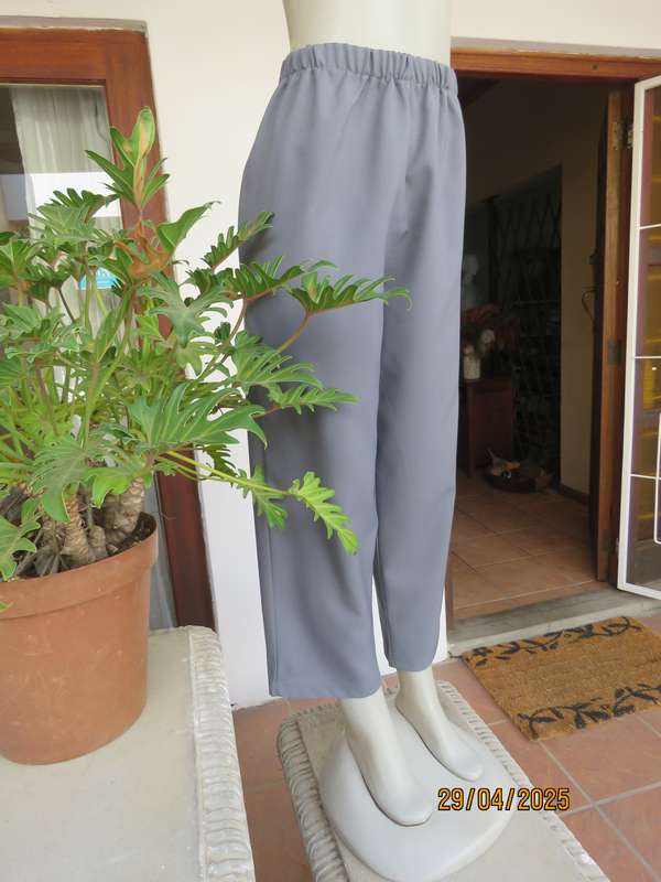 Boutique made hailstorm grey 100% polyester with elasticated waist. Size 40