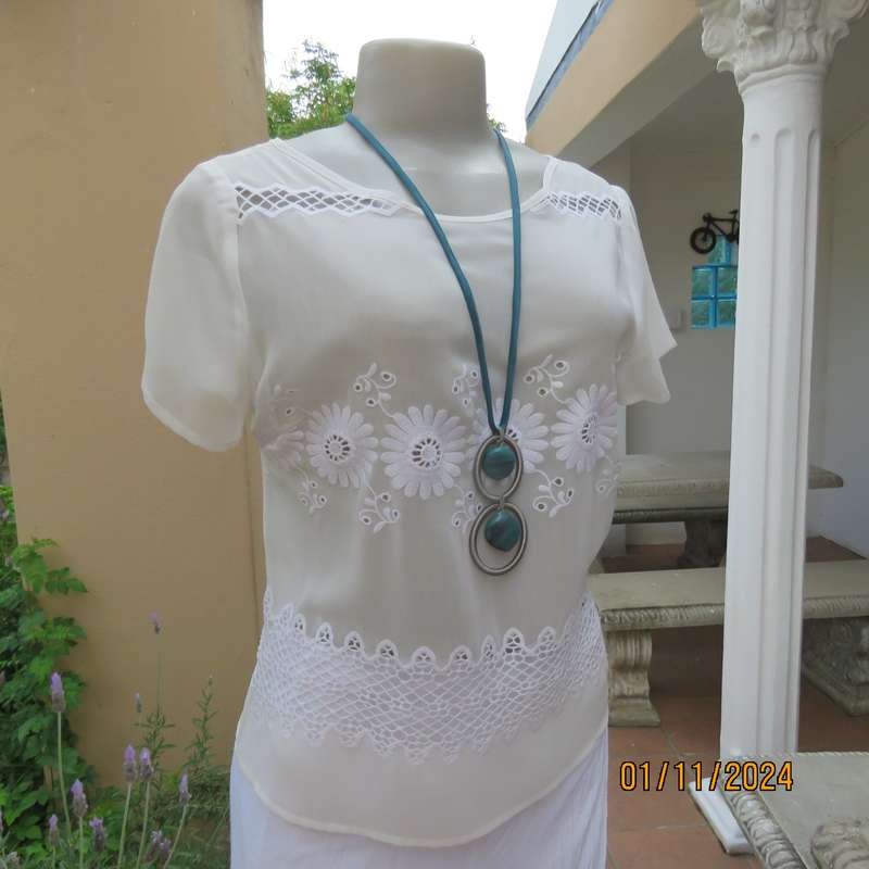 Dainty light cream short sleeve slip over sheer poly top.Bold floral embroidery on front.Size 32,