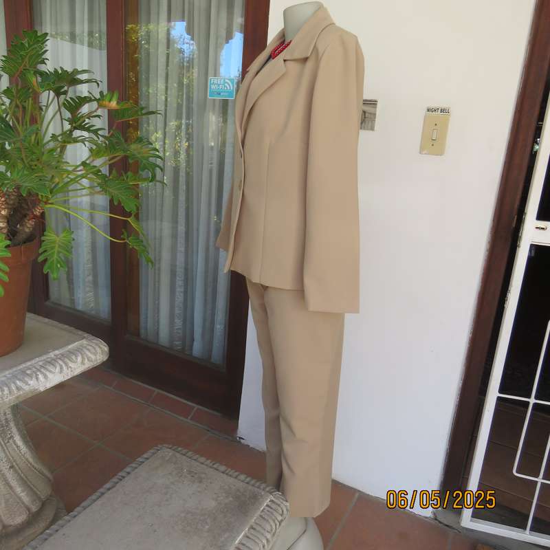 Boutique made rich cream 2pc pantsuit. Long sleeve jacket with 2 button closure. Size 40.