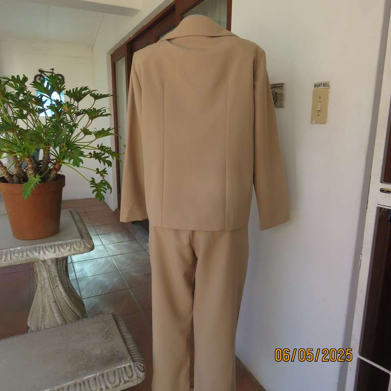Boutique made rich cream 2pc pantsuit. Long sleeve jacket with 2 button closure. Size 40.
