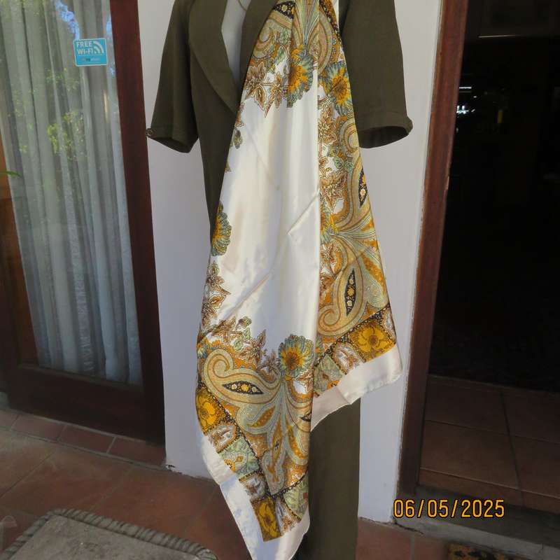 Square 90cm x 90cm cream satin polyester scarf with paisley pattern border in autumn colours.
