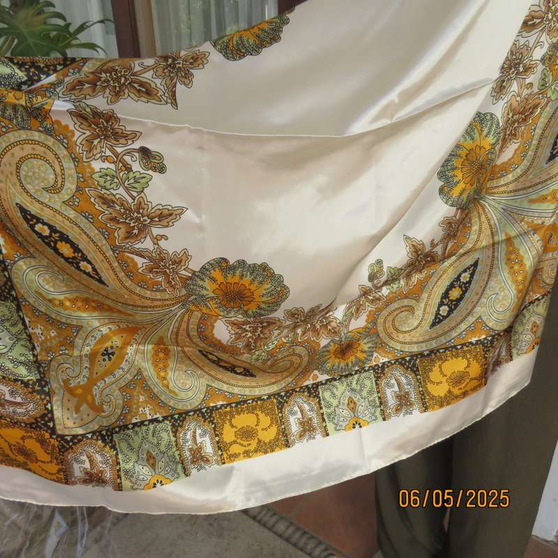 Square 90cm x 90cm cream satin polyester scarf with paisley pattern border in autumn colours.