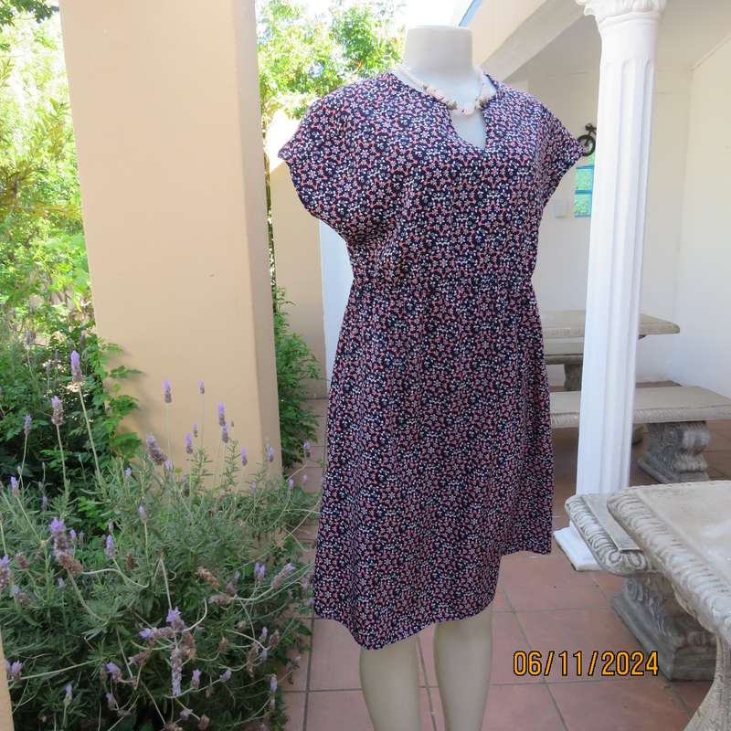 Cool maternity empire style dress in poly-rayon blend.Navy with white-pink flowers.Size 32-34.As new