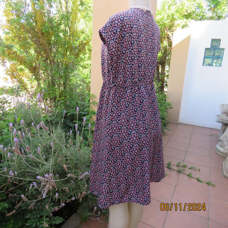 Cool maternity empire style dress in poly-rayon blend.Navy with white-pink flowers.Size 32-34.As new