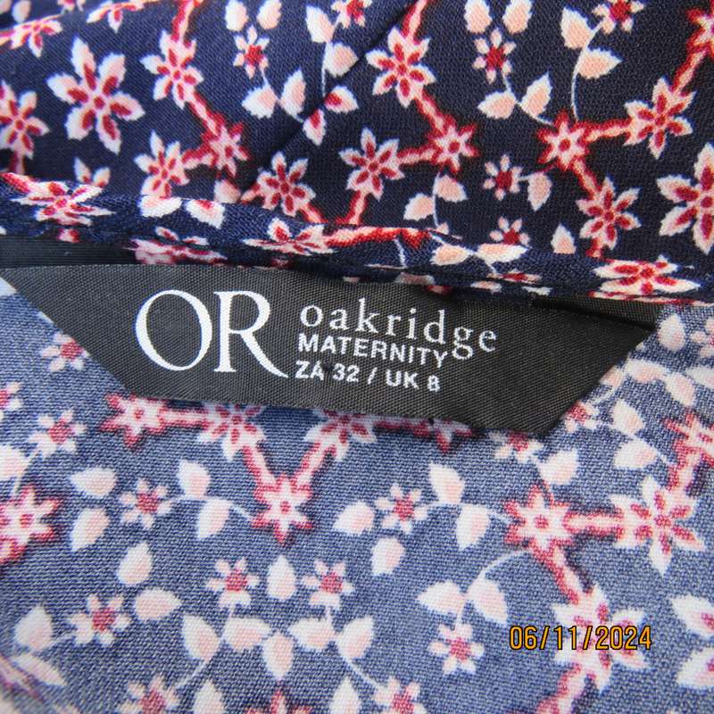 Cool maternity empire style dress in poly-rayon blend.Navy with white-pink flowers.Size 32-34.As new