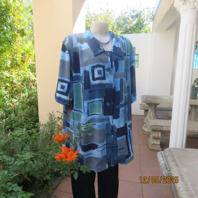 Short sleeve button down top in medley of blues. Geometric print in polyester. Size 44.