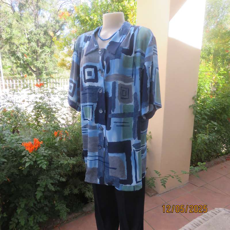 Short sleeve button down top in medley of blues. Geometric print in polyester. Size 44.