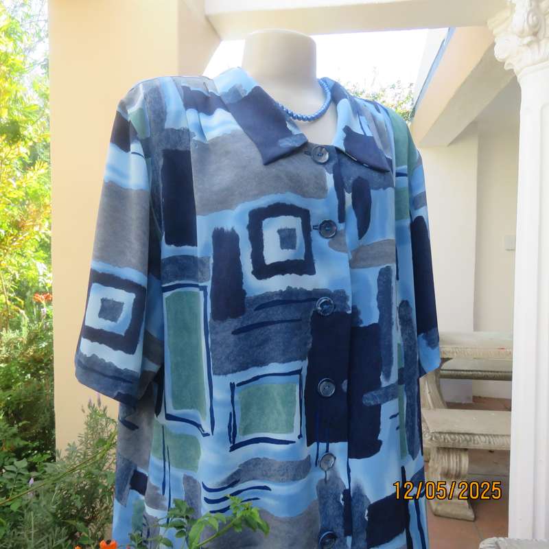 Short sleeve button down top in medley of blues. Geometric print in polyester. Size 44.