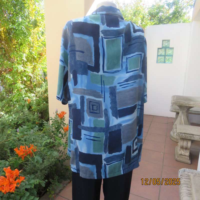 Short sleeve button down top in medley of blues. Geometric print in polyester. Size 44.