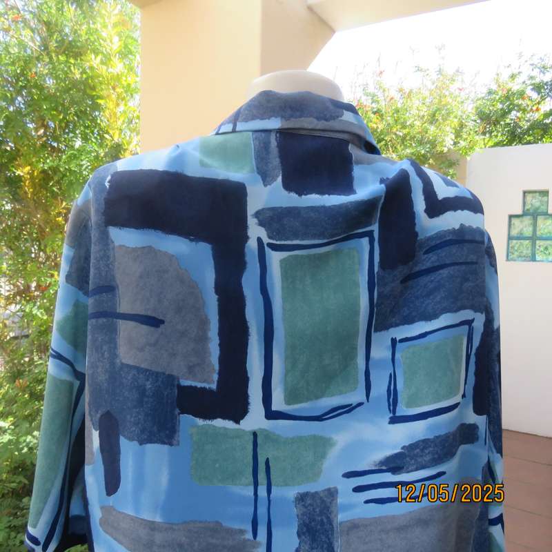Short sleeve button down top in medley of blues. Geometric print in polyester. Size 44.