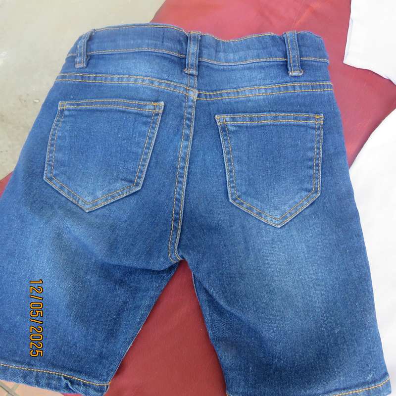 Set of blue denim jean shorts and white golf shirt for 6 to 7 year old boy.