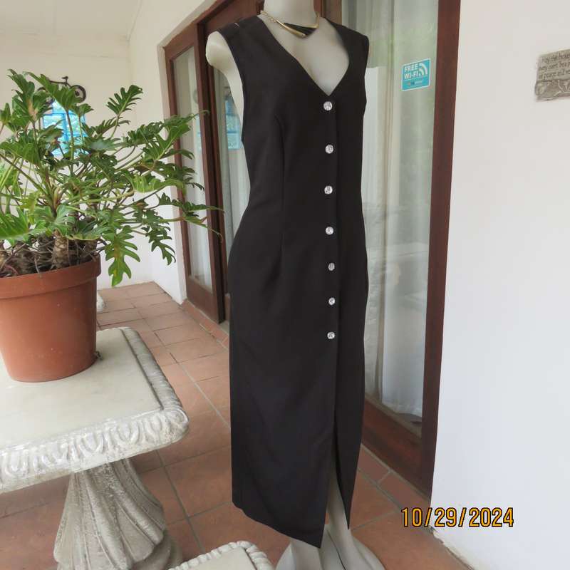 Beautiful black sleek button down ankle length dress by CHARLOTTE size 36. Criss cross strap back.