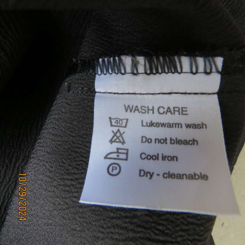 Beautiful black sleek button down ankle length dress by CHARLOTTE size 36. Criss cross strap back.