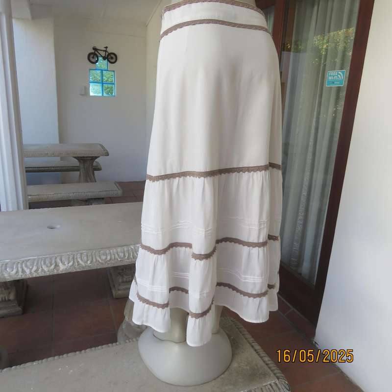 Ankle length light cream polycotton tiered bandless skirt. Tucking and lace decoration. Size 34