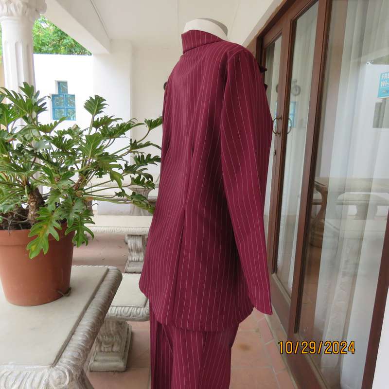 Classic maroon-white pinstripe 2 pc pantsuit. In 100% polyester. Tailored 1 button jacket. Size 40.