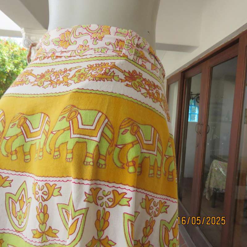 Wrap around 100% cotton size 44-44 skirt in horizontal elephant-floral patterns.