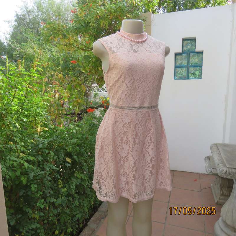 RT pale peach polyester lace mini dress with stretch poly lining. Size 32. Pleated bottom