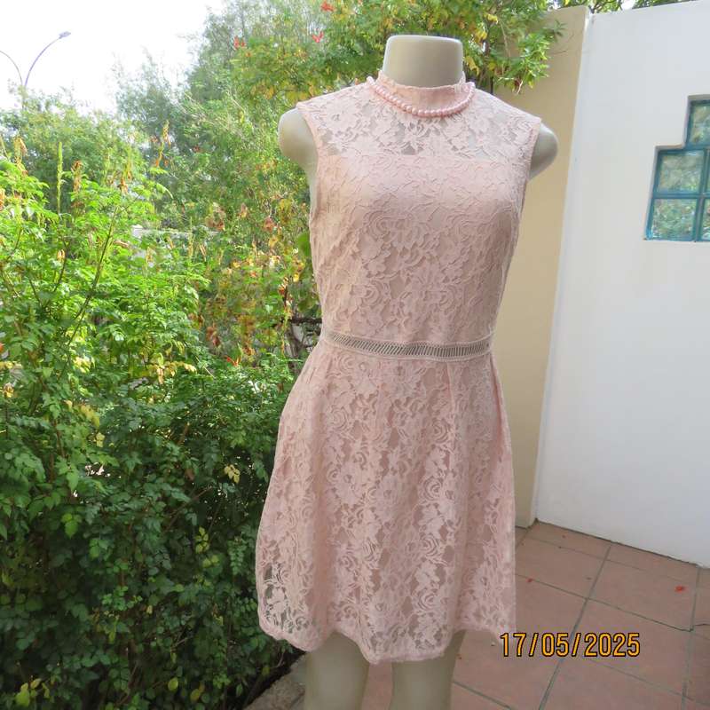 RT pale peach polyester lace mini dress with stretch poly lining. Size 32. Pleated bottom