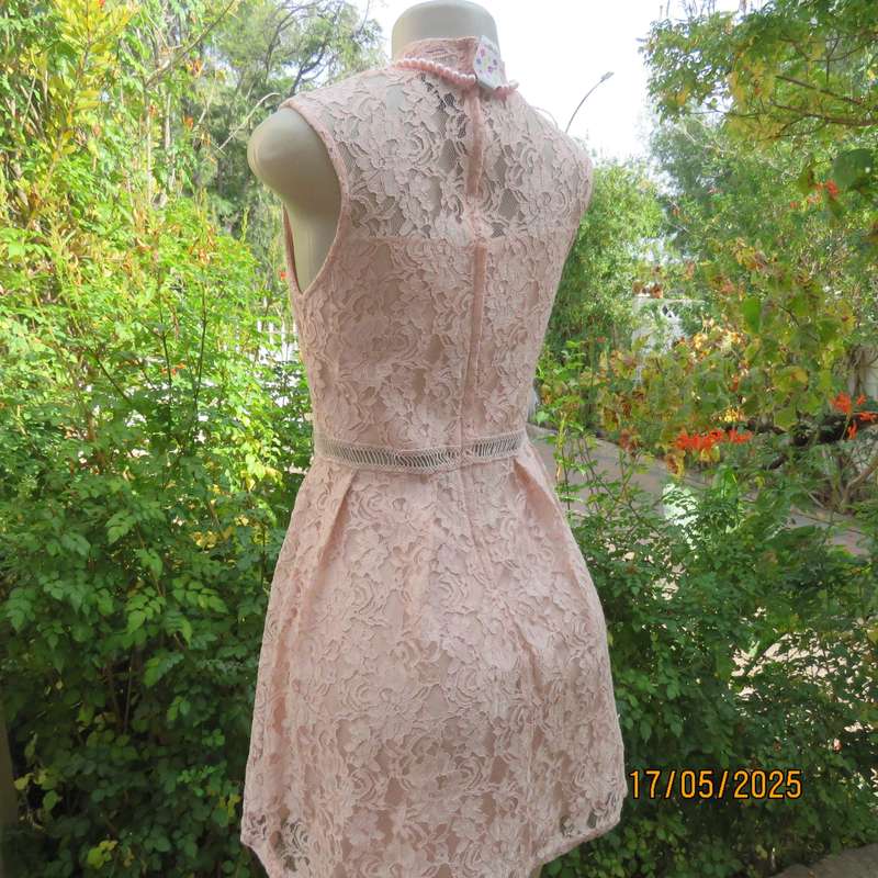 RT pale peach polyester lace mini dress with stretch poly lining. Size 32. Pleated bottom