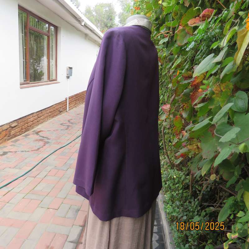 Dark purple boutique made long sleeve elegant partly lined collarless jacket. Size 42-44