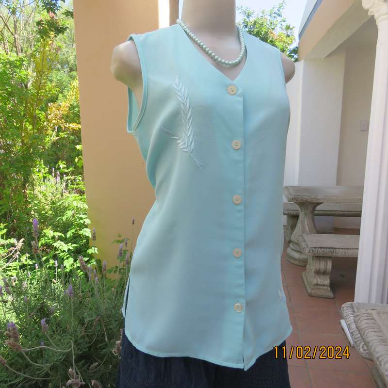 Look chic in this aqua colour sleeveless V neck top.Button down. Leaf embroidery.Size 34. As new