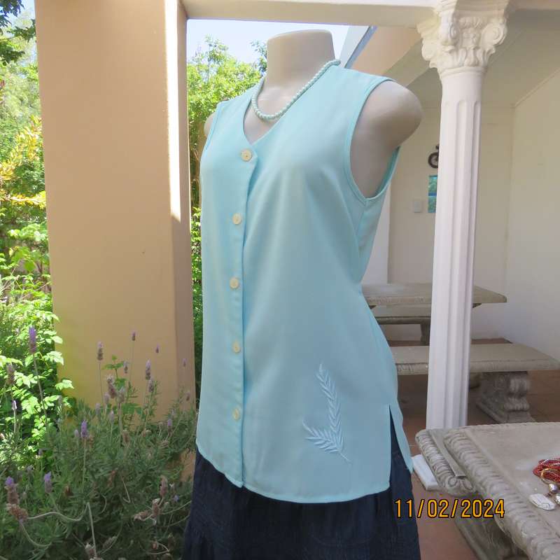 Look chic in this aqua colour sleeveless V neck top.Button down. Leaf embroidery.Size 34. As new