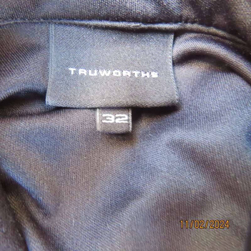 TRUWORTHS black long sleeve stretch polyester size 32 top. With braiding on the front.As new