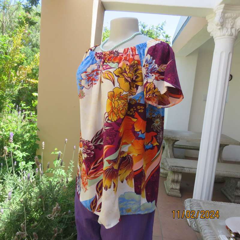 Easy to wear OR size 40-42 slip over off the shoulder top in cream-purple-blue-orange flowers.As new