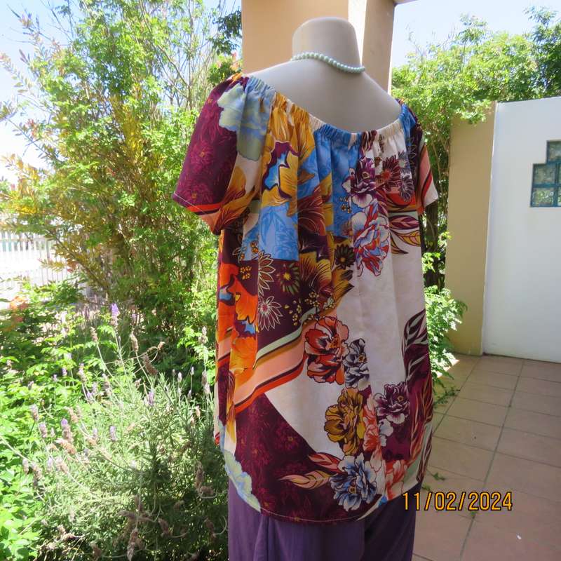 Easy to wear OR size 40-42 slip over off the shoulder top in cream-purple-blue-orange flowers.As new