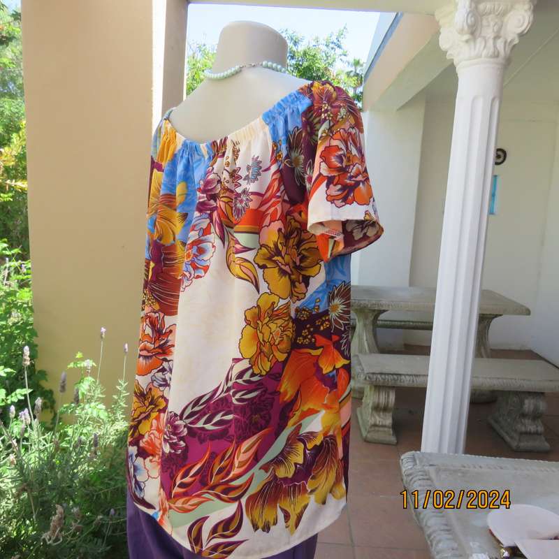 Easy to wear OR size 40-42 slip over off the shoulder top in cream-purple-blue-orange flowers.As new
