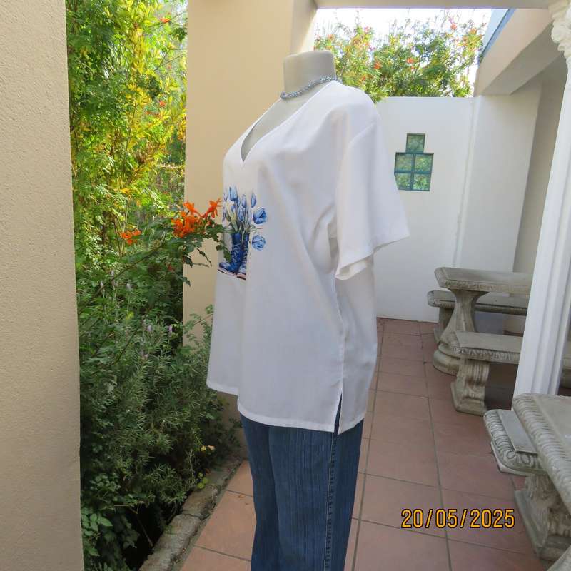 Unique boutique made white V neck short sleeve top. Blue print on front. Size 40